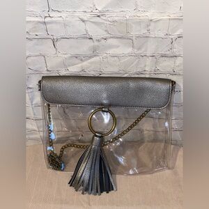 M.B. Greene Clear Crossbody Bag with Metallic Silver Flap and Tassel Accent
